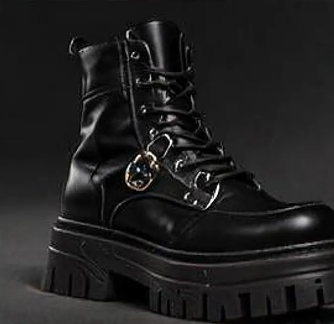 Heavy black platform boot with a steel buckle